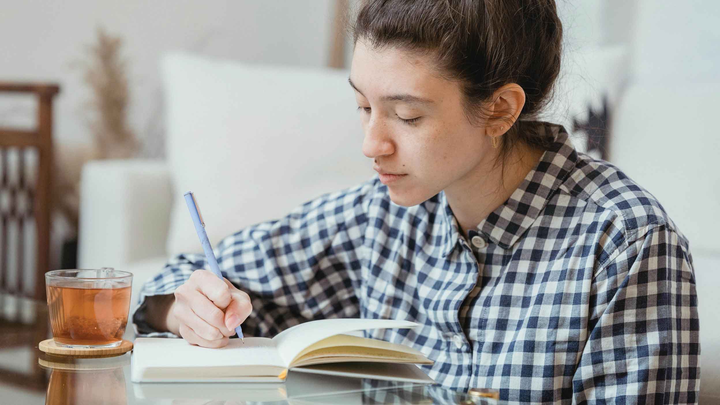 women writing in notebook